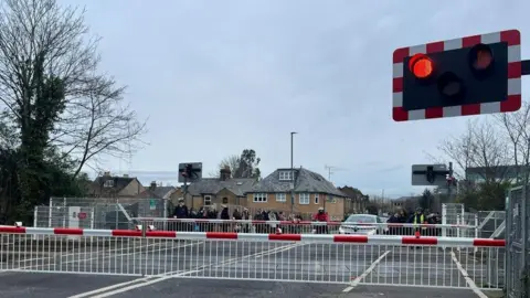 Egham residents wait at level crossing in October 2023