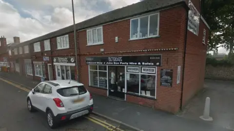 Google The outside of the Betterdaze record shop in Northallerton, a small white car is parked outside 