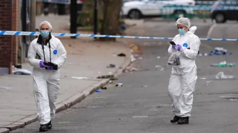 Jacob King/PA Wire Forensic investigators at the scene in Friar Gate, Derby, on Sunday 29 March 2026.
