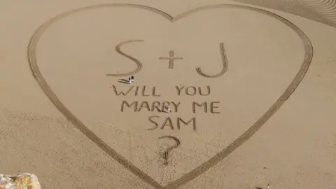 @d0oner a giant love-heart drawn in sand on brean beach