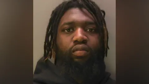 Sussex Police Jahmal Swaby in a police mugshot with a stern expression.