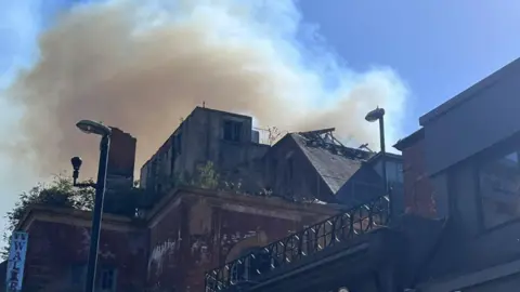 Smoke in the air around a derelict building 