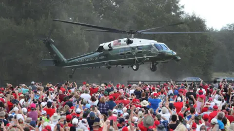 Getty Images The Marine One helicopter lands in front of a huge crowd