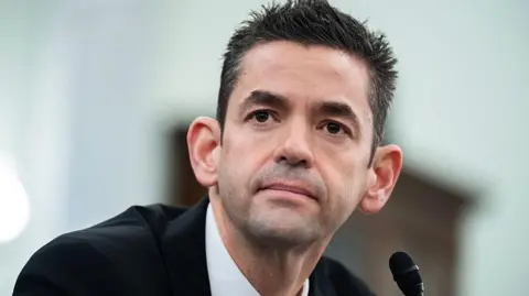 Jared Issacman in front of microphone