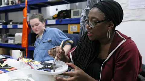 Volunteers repair electrical items at the Fixing Factory in Camden, London