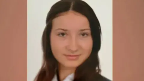 Police handout School photograph of Scarlett Vickers, a white girl with brunette hair part tied back smiling at the camera