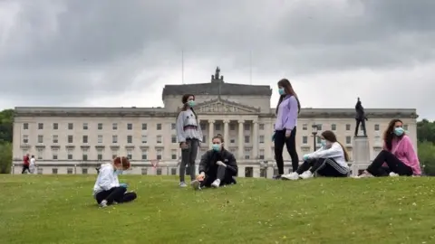 Getty Images Teenagers wearing masks outside Stormont