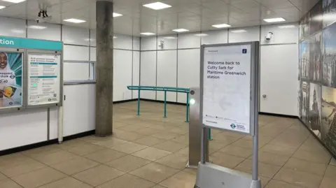 TfL Picture of the inside of the refurbished Cutty Sark station, showing a notice board with the words 'Welcome back to Cutty Sark for Maritime Greenwhich station'