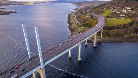 Getty Images An aerial view of the Kessock Bridge, Beauly Firth and an area of headland with the village of North Kessock along its shoreline.
