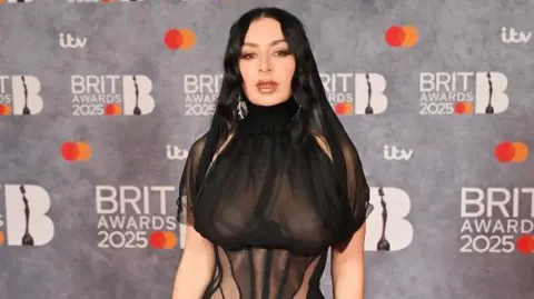 Getty Images Charli XCX on the red carpet dressed in black