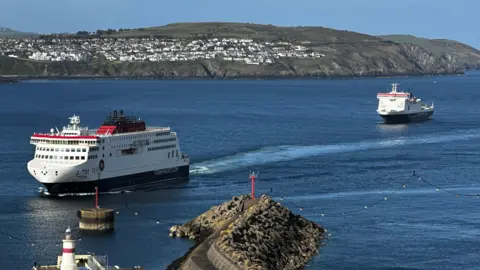 The Manxman ferry sailing into Douglas Harbour with the Ben-my-Chree in the bay behind. Onchan Head is in the background.