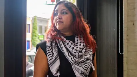 Chris Gale Jinan Deena poses for a photo at a restaurant in Washington DC