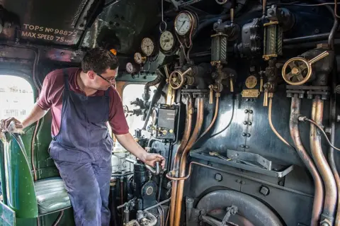 Getty Images An engineer operates the controls on the footplates of the Flying Scotsman