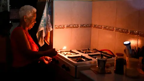 Gladys Valdes, 76, prepares coffee during a blackout as Cuba's national electric grid collapsed, according to the country's grid operator, leaving around 10 million people without power amid a U.S.-imposed oil blockade, in Havana, Cuba March 16, 2026.