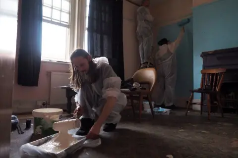 Ed Gold People painting walls with roller brushes