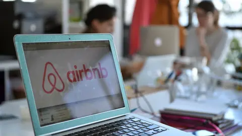 Getty Images The Airbnb logo on a computer screen in the company's office in Paris