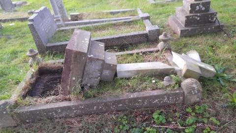 A toppled and smashed gravestone