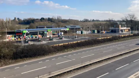 Luke Deal/BBC A picture of a petrol station. In front of the petrol station there are roads.