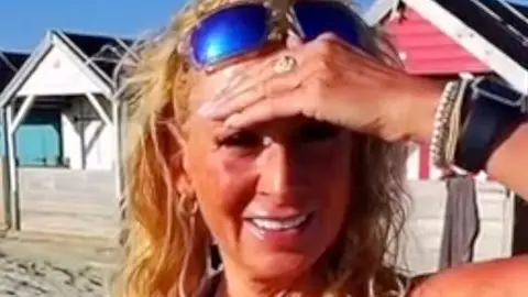 Kim is wearing blue sunglasses.