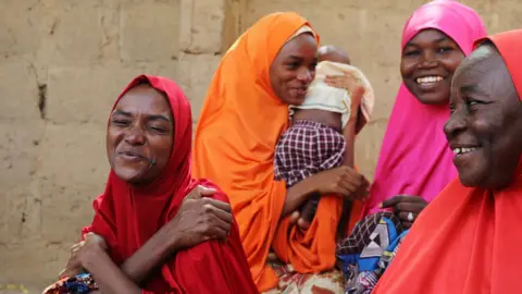 Reuters The mother of three of the newly-released Dapchi schoolgirls reacts in Dapchi, in the northeastern state of Yobe, Nigeria