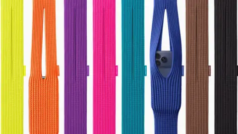 A display of eight brightly coloured knitted iPhone Pocket bags, two with iPhones in them, coloured from the left yellow, orange, purple, pink, turquoise, blue, brown and black.