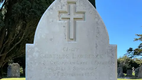 NRWGC Inscription in French on the reverse side of the restored white gravestone. It reads: Clotilde Lawrence. Nee a St Germain-en-Laye, France. Decedee a Studland, le 26 Septembre 1853.