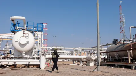 EPA A Syrian soldier stands at al-Omar oil field following the withdrawal of the Syrian Democratic Forces (SDF) from Deir al-Zour province, Syria (19 January 2026)