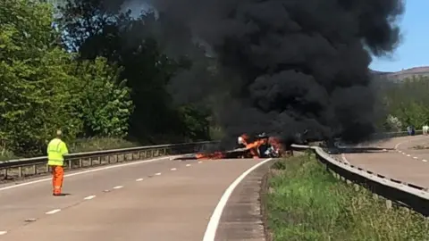 Martin Barnfield Plane in flames on the road