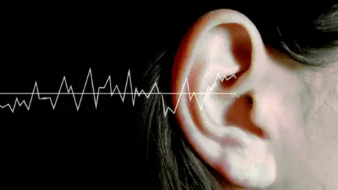 Conceptual image of sound waves and woman's ear