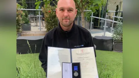 Bradford Teaching Hospitals Dean Priestley with his bravery award