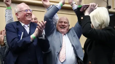 PA/Damien Storan Senator Michael McDowell (left) with No campaigners celebrate at Dublin Castle as the result is announced in the first of the twin referenda to change the Constitution on family and care. Ireland has voted to reject the Government's proposal to change the constitution on family, with 67% of people voting against the amendment