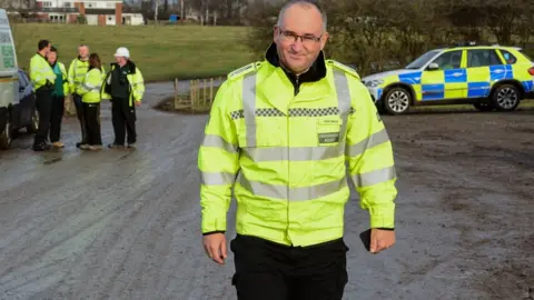 Dave Throup Dave Throup with police on a raid of an illegal waste site