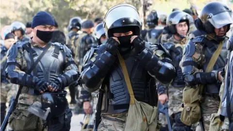 Reuters Kyrgyz law enforcement officers are seen near the Ala-Archa state residence outside Bishkek, Kyrgyzstan October 15, 2020.