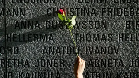 Getty Images A flower is pictured on a granite wall bearing the names of the victims of the 1994 sinking of the "Estonia" car ferry in the Baltic Sea in 2004.