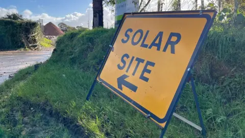 A sign by the road saying 'Solar Site'