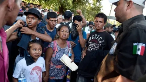 Getty Images Central American asylum seekers confronted by Mexico security officials last month