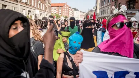 Reuters People of all backgrounds with makeshift coverings in Copenhagen