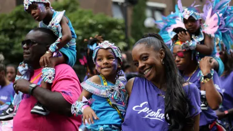 Reuters: Children are carried through the streets 