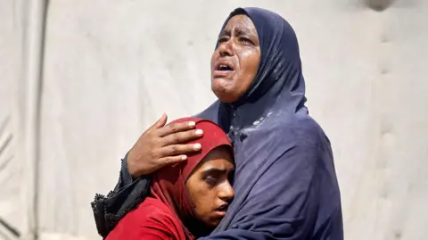 Reuters Palestinians, who fled the eastern part of Khan Younis after they were ordered by Israeli army to evacuate their neighborhood, react upon their arrival at Nasser hospital, amid Israel-Hamas conflict, in Khan Younis in the southern Gaza Strip July 2, 2024