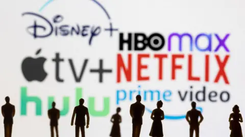 Reuters An illustration showing logos for streaming platforms Disney+, HBO Max, Apple TV+, Netflix, Hulu and Prime Video with silhouettes of eight people standing in front of them. 
