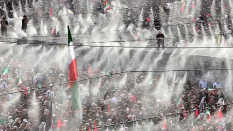 EPA Hundreds of supporters gathered in Tehran for the state funeral with water being sprayed