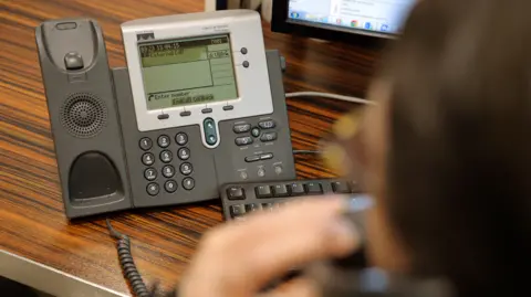 Stock image of a phone in an office