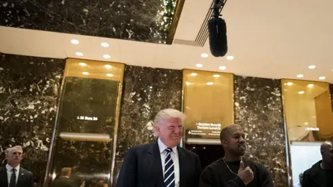 Getty Images Donald Trump and Kanye West outside the famous gold elevators at Trump Tower, New York City, in December 2016.