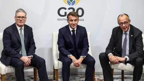 PA Media German Chancellor Friedrich Merz, French President Emmanuel Macron, Ukranian President Voloydmyr Zelensky, and British Prime Minister Keir Starmer sit next to one another.