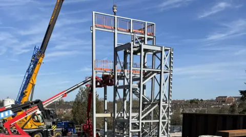 Kettering General Hospital Construction workers using machinery to assemble steel beams for the structure of the energy centre.