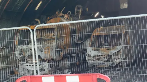 Fire damaged cars parked next to each other 