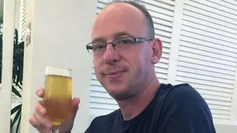 Nottinghamshire Police A man holding a beer