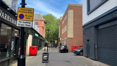 Shariqua Ahmed /BBC Wentworth Street with no parking signs and two cars parked up 