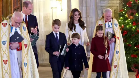 Getty Images Catherine, Princess of Wales, Prince Louis of Wales, Princess Charlotte of Wales, Prince William, Prince of Wales and Prince George of Wales process out of The "Together At Christmas" Carol Service at Westminster Abbey on December 08, 2023 in London, England.