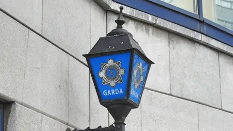 Getty Images A lantern attached to a building. It shows the gardai's emblem. 